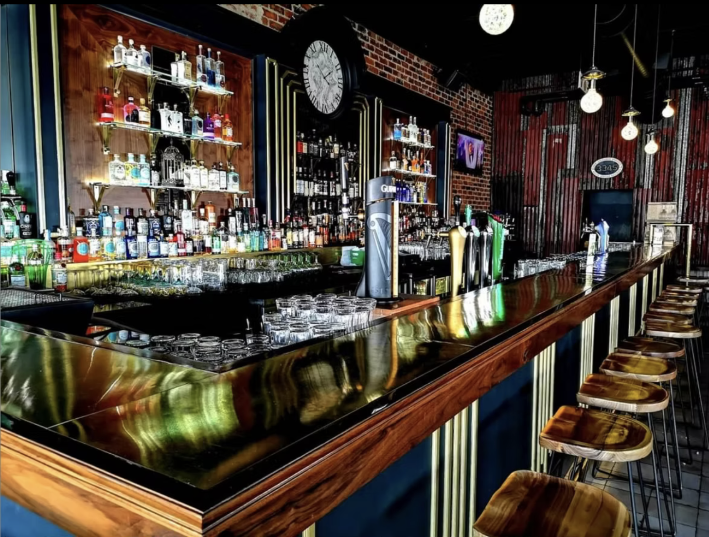 The Jozi Gin bar counter with beer taps, bottle shelves and pendant lights