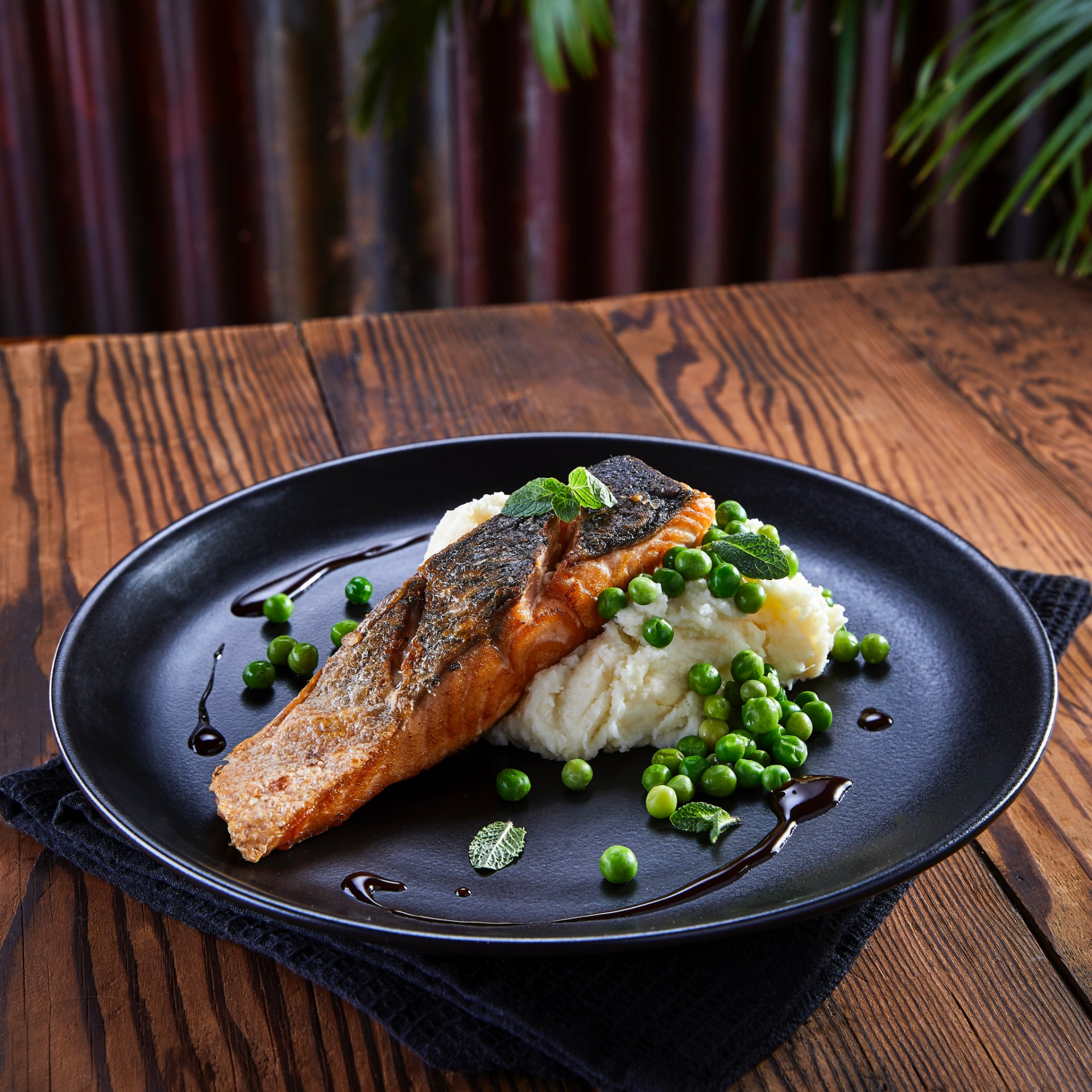 Crispy-skin salmon with mash, peas and balsamic at Jozi Gin